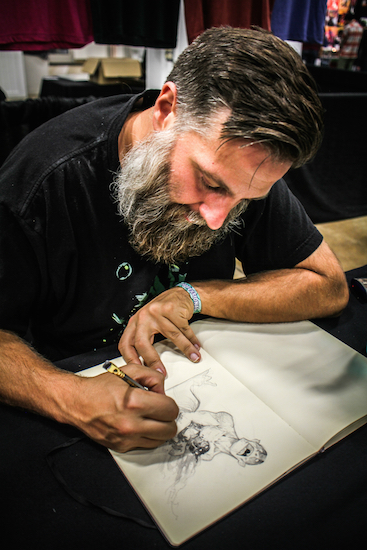 Comic book artist at work at Big Adventure