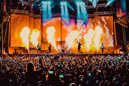 Monster Energy Carolina Rebellion crowd with the main stage lit by pyrotechnics