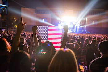 Fan flies the American flag at Lost Highway 2015