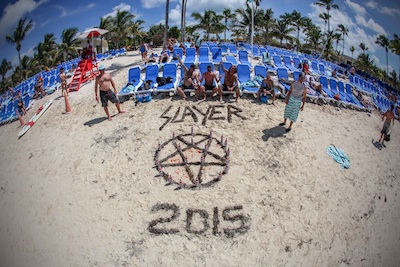 Motörhead's Motörboat guests craft a Slayer logo on the beach at Great Stirrup Cay