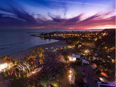 Aerial photo of an event crowd at Doheny State Beach at sunset